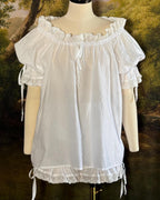 Close-up of the lace-trimmed sleeve tie on the white chemise