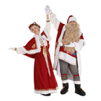 Mrs. Claus and Santa waving in matching red folk outfits