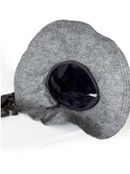 Underside of the grey hat showing the dark cotton lining