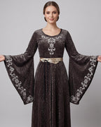 Woman in the sage grey-green velvet medieval dress with bell sleeves