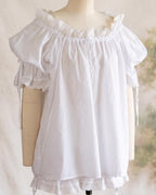 Front of the white chemise showing the lace-trimmed hem