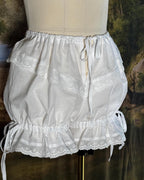 Bloomers on a dress form with the legs gathered short
