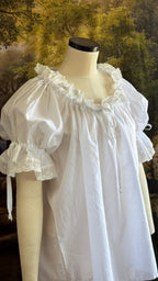 Close-up of the puffed sleeve and lace cuff of the chemise