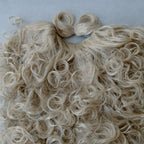 Close-up of the blond synthetic curls