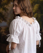 Side view of the chemise showing the ruffled lace cuff ties