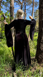 Back lacing of the brown velvet dress shown outdoors