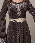 Cream eyelet belt cinching a grey-green velvet medieval dress