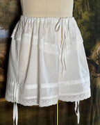 White cotton bloomers with side ties on a dress form