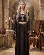 Full-length sage velvet gown worn in a candlelit medieval hall