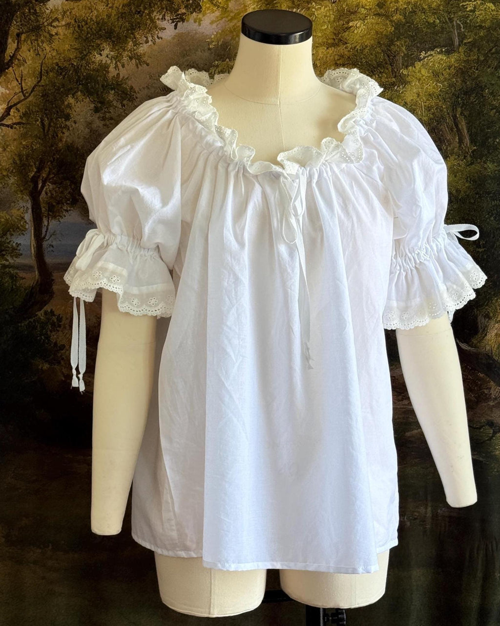Chemise on a dress form with the neckline worn on the shoulders