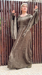 Elven dress worn against a bamboo fence, arms raised