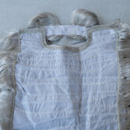 Inside of the grey wig showing the lace cap and elastic straps