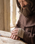 Hands and sleeve of the monk costume with the brown wig in view