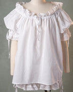 The chemise on a dress form, elasticated neckline drawn with a tie
