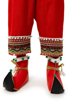 Detail of the red elf trousers, pompom trim and curled shoes