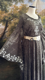 Sage velvet gown on a dress form with the sleeve trim in view