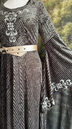 Detail of the silver bodice appliqué and the cream lace-up belt